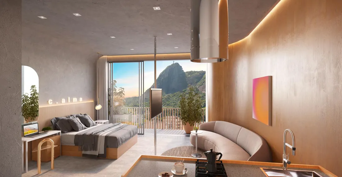 Studio decorado do First Humaitá com cozinha integrada e varanda com vista para o Corcovado